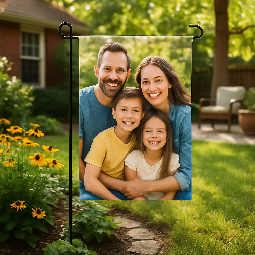 A cozy backyard scene featuring a vibrant, personalized garden flag with a smiling family photo, fluttering gently in the breeze. Alt: Custom photo garden flag gift showing a happy family outdoors.
