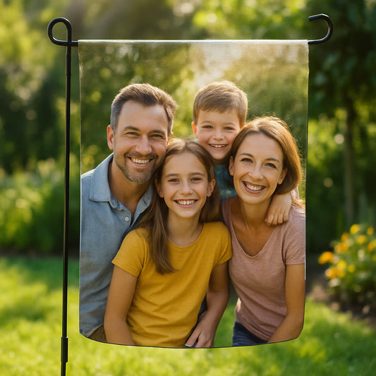 A garden flag fluttering in bright sunlight, showing a custom family photo printed on durable nylon fabric. Alt: custom photo garden flag gift durable material