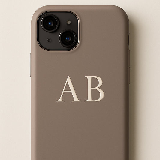 A sleek phone case with elegant monogram initials, soft matte finish, close-up view. Alt: custom name phone case monogram style