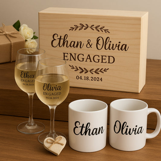 A beautifully arranged assortment of personalized engagement gifts including a wooden box, wine glasses, and custom mugs. Alt: Personalized engagement gift ideas showcasing wooden keepsake box, engraved wine glasses, and custom name coffee mugs.
