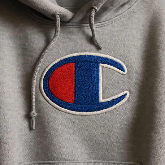 A close-up of a cozy, thick hoodie featuring a crisp, colorful embroidered logo on the chest. Alt: Personalized embroidered hoodie showing detailed vibrant stitching on soft fabric
