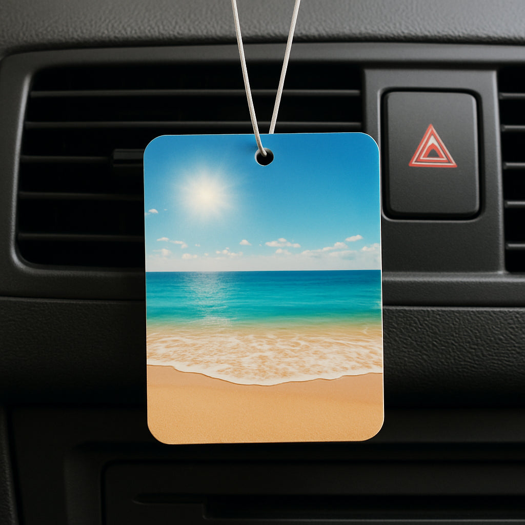 A personalized photo air freshener hanging from a car vent with a sunny beach photo, showcasing the vibrant print and subtle scent diffusion. Alt: Personalized photo air freshener with beach image.